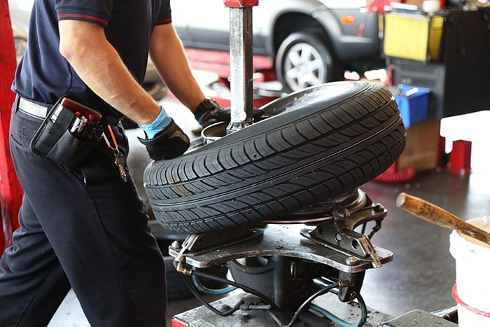 Mechanic fitting a tyre