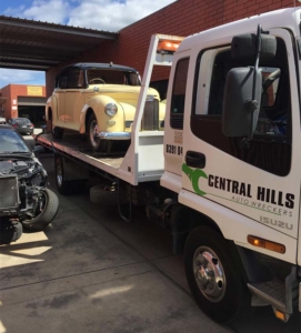 Tow truck with old car on the back