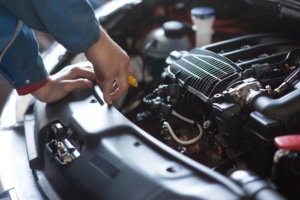Mechanic fixing car engine
